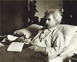 Mark Twain writing in bed