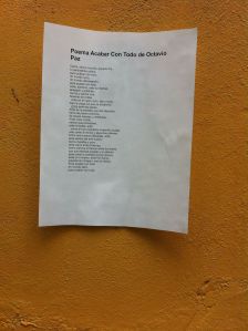 Poem stuck on wall lamenting the excess of celebration over Octavio Paz Centenary.